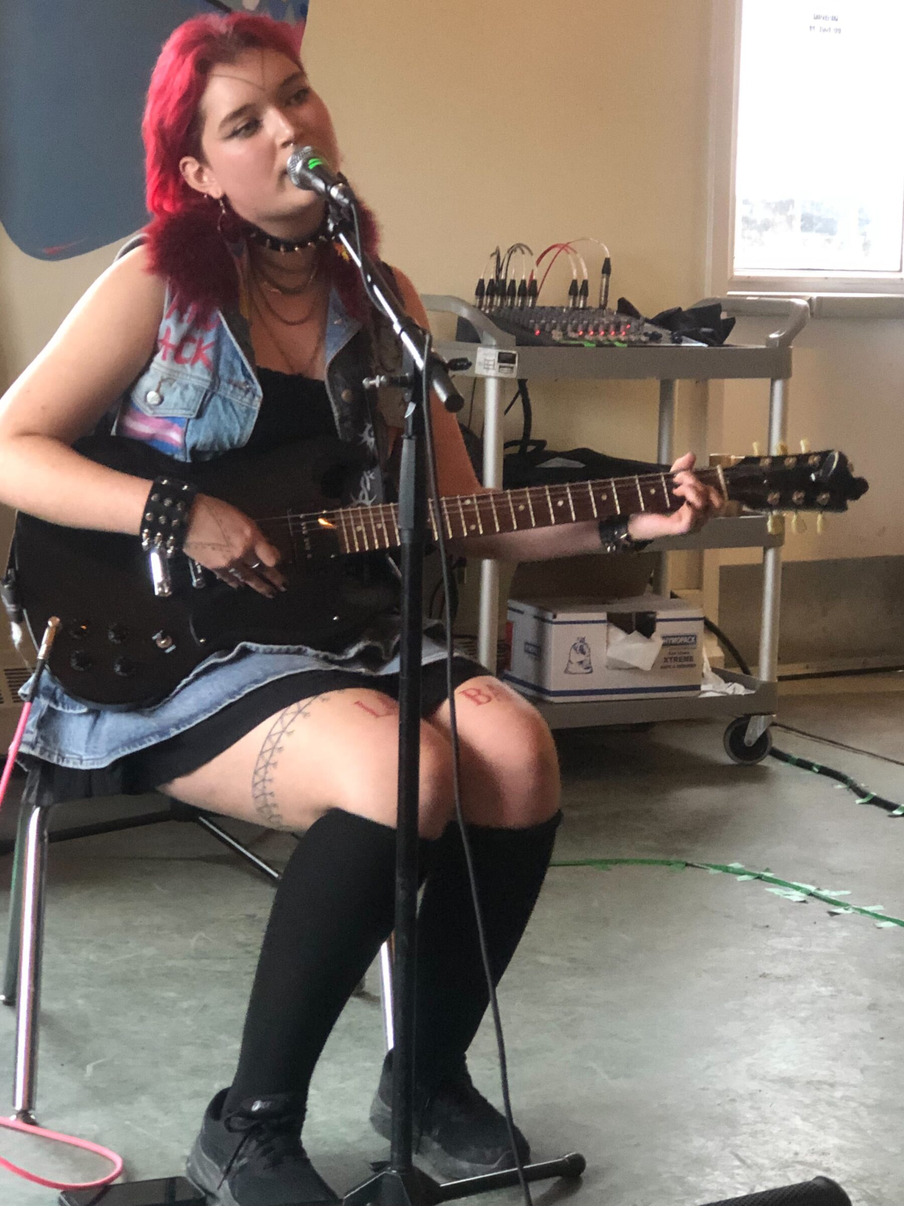 Kuujjuaq recording artist Niivi Snowball performs “No Pride in Genocide,” Thursday at the Qajuqturvik Community Food Centre in Iqaluit. The musician was part of the lineup for the rainbow potluck and variety show hosted by the centre for Pride Month. Snowball performs again in the city this weekend as part of the Alianait Arts Festival. (Photo by Daron Letts)