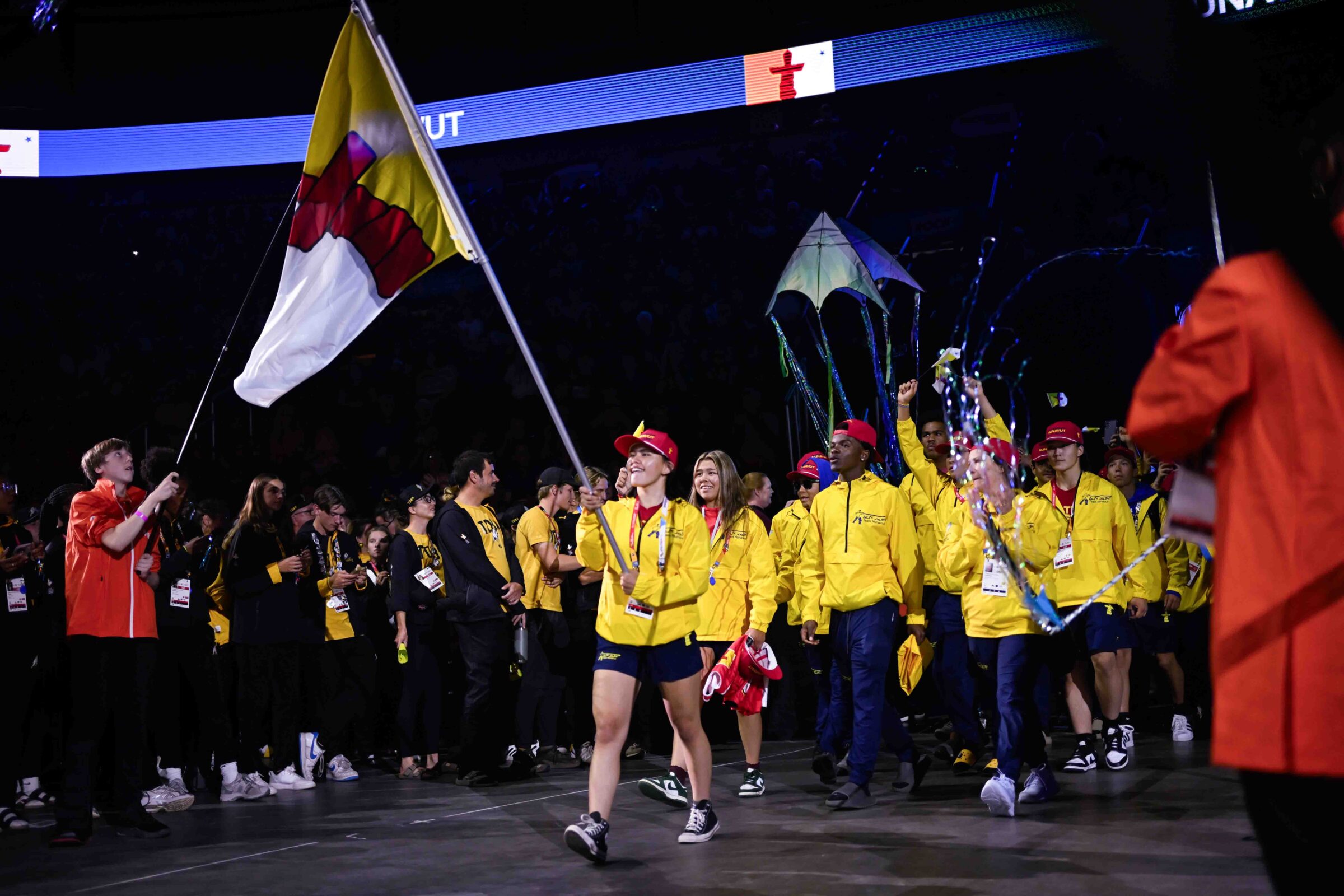 Kaneena Netser of Rankin Inlet carries Nunavut’s flag during the closing ceremony for the Canada Summer Games in St. John’s, N.L., on Aug. 24. (Photo courtesy of Eric Bartlett/Canada Summer Games)