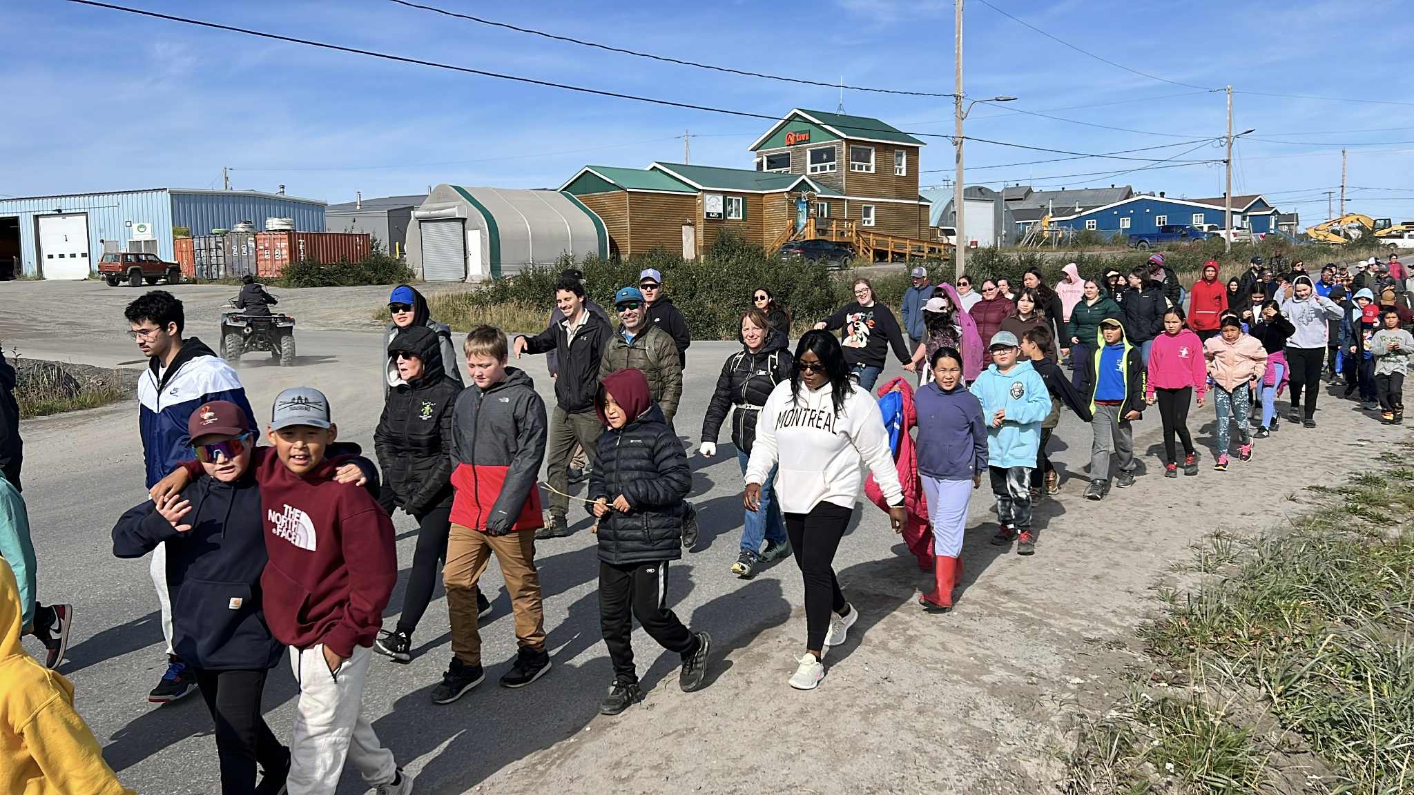 Kuujjuaq residents march along Airport Road on Friday as part of the village’s Celebration of Life Walk. The event was part of Suicide Prevention Month, which is observed in September. Participants walked from Jaanimmarik School to the Kuujjuaq Forum. The walk took place two days after World Suicide Prevention Day, which is observed around the world on Sept. 10. (Photo by Malaya Qaunirq Chapman, special to Nunatsiaq News)