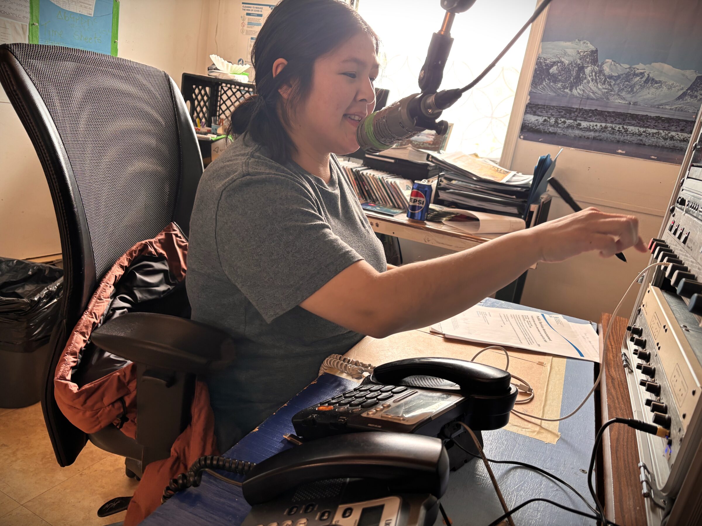 Karen Alivaktuk broadcasts a public service announcement Tuesday as a host on Pangnirtung’s community radio station. Formerly a weekend host, Alivaktuk recently switched to hosting her show on weekdays. She reads announcements and invites community members to come on-air to read their own well-wishes. Other hosts at the radio station call bingo games over the airwaves for their listeners to play at home. (Photo by Daron Letts)