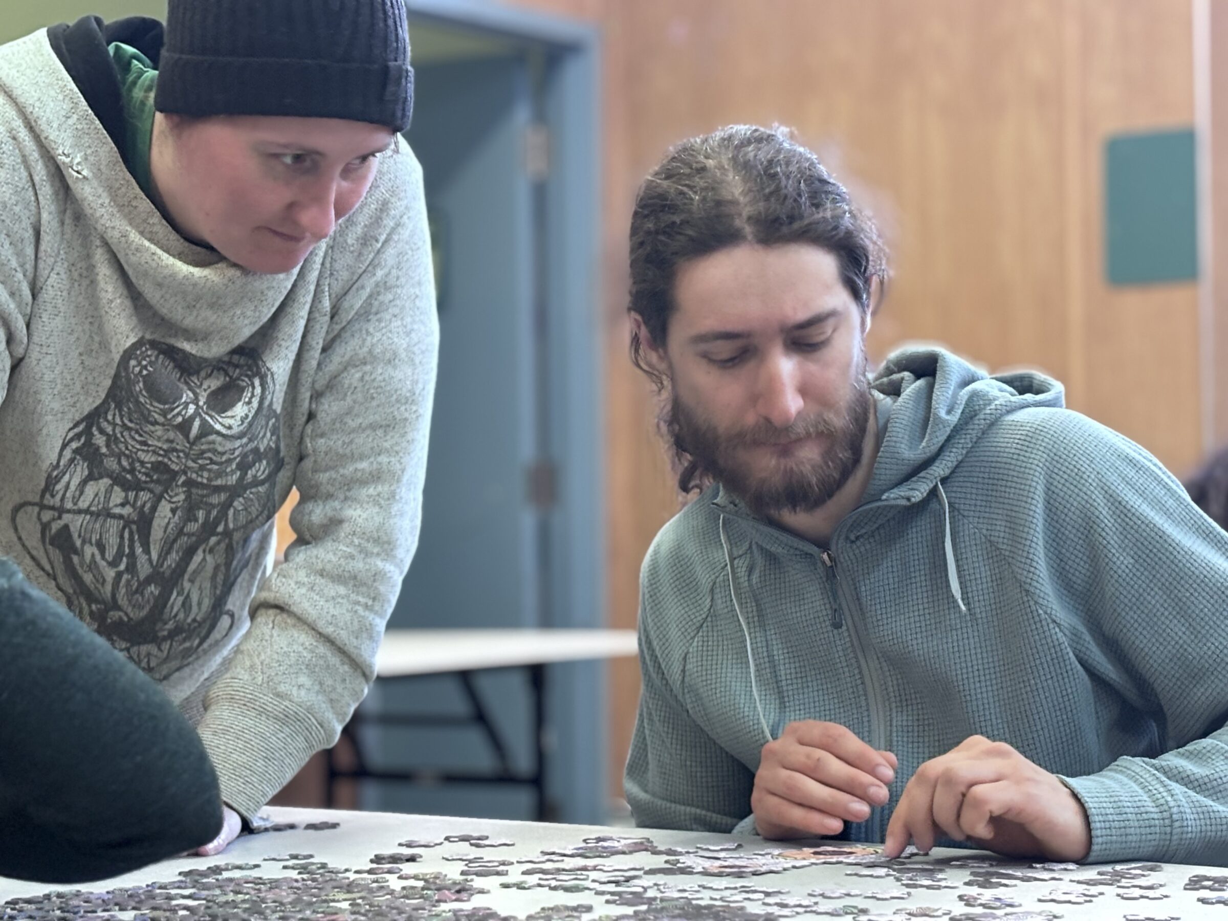 Jordan Blake, left, and James Elliott compete in the Toonik Tyme puzzle challenge at Abe Okpik Hall in Apex on Sunday evening. Eight teams of three competed for more than $1,000 in prizes in the 500-piece and 1,000-piece categories. The competition took place after the end of last month’s festival because the puzzles arrived late in the mail. (Photo by Daron Letts)